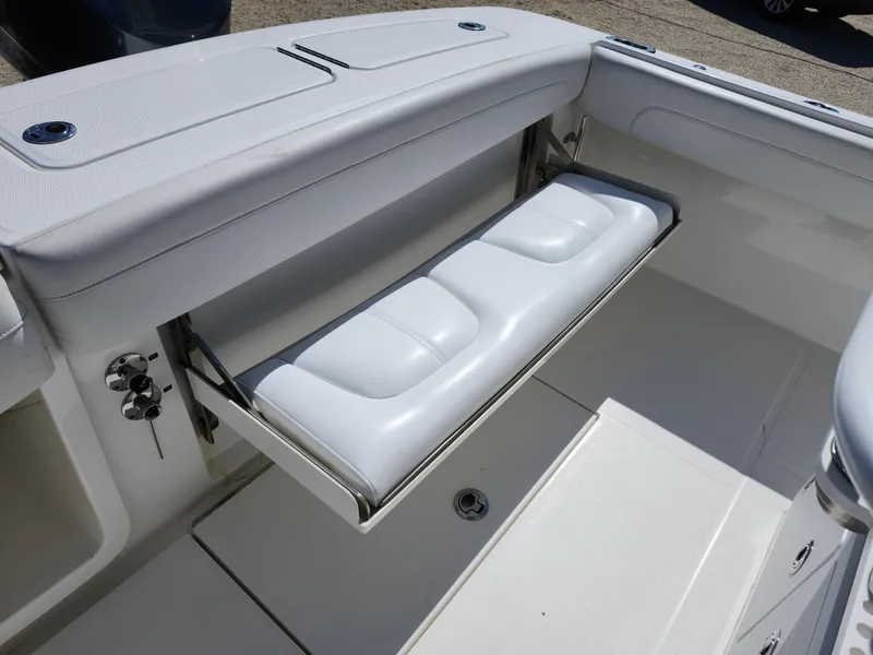 Slide: The Image of 2020 Regulator 25 boat with foldable white seat in cockpit area. - 12