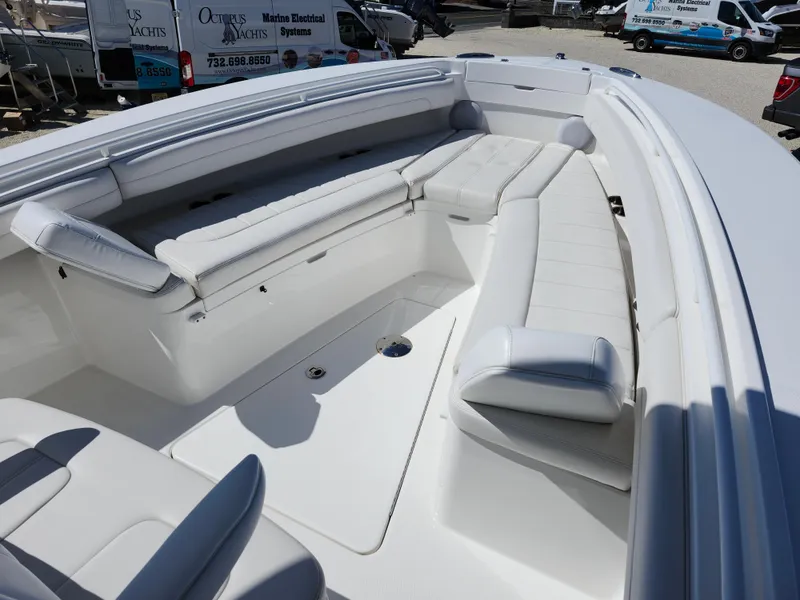 Slide: The Image of 2020 Regulator 25 boat interior with white cushioned seating and spacious deck. - 13