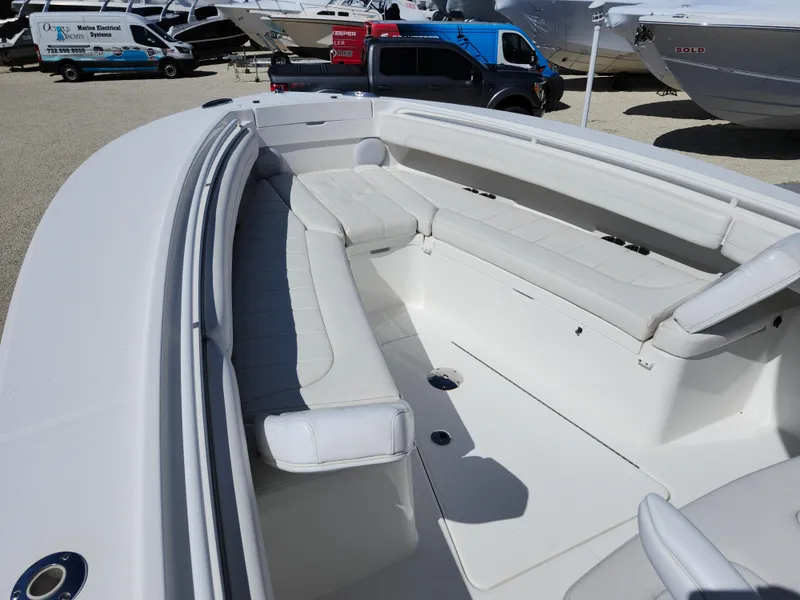 Slide: The Image of 2020 Regulator 25 boat with spacious seating and sleek design in a marina setting. - 14