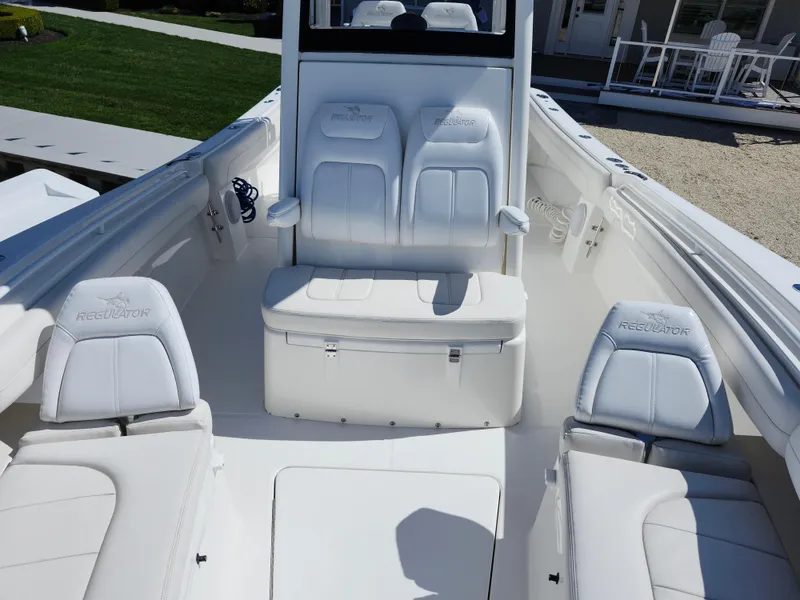 Slide: The Image of 2020 Regulator 25 boat interior with white seating and console. - 17