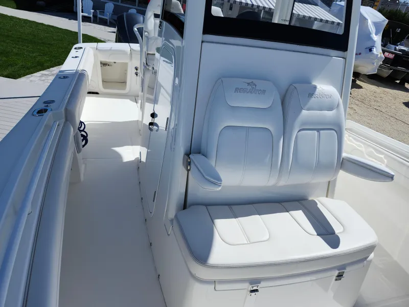 Slide: The Image of 2020 Regulator 25 boat interior with white seating and console. - 18