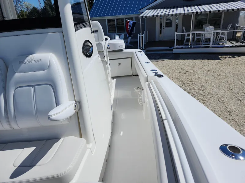 Slide: The Image of 2020 Regulator 25 boat interior with white seating and sleek design. - 19