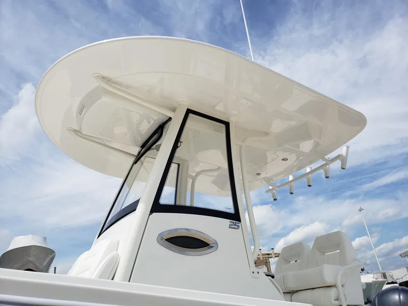 Slide: The Image of 2020 Regulator 25 boat with T-top against a blue sky background. - 20