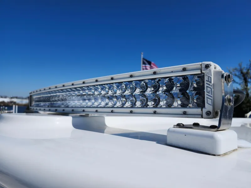 Slide: The Image of LED light bar on 2020 Regulator 25 boat against clear blue sky. - 24