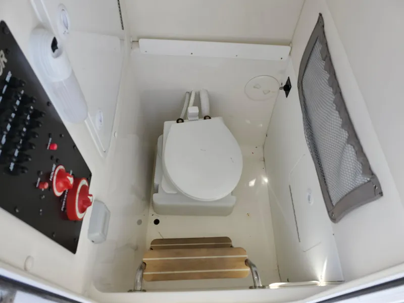 Slide: The Image of 2020 Regulator 25 boat interior with toilet and control panel. - 27