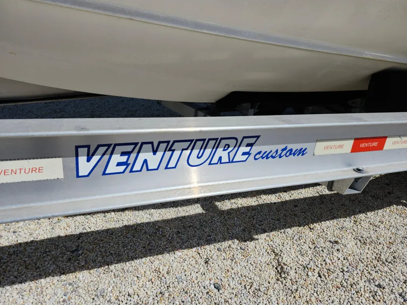 Slide: The Image of Trailer for 2020 Regulator 25 boat, featuring Venture Custom branding. - 31