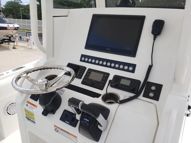 Slide: The Image of Control panel of a 2020 Regulator 25 boat with steering wheel and navigation equipment. - 9