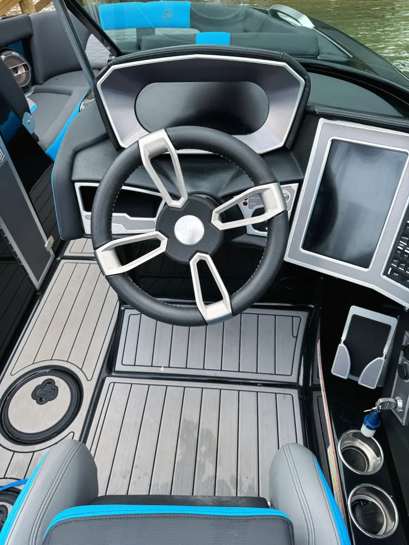 Slide: The Image of 2019 MasterCraft X24 boat cockpit with modern steering wheel and digital display. - 5