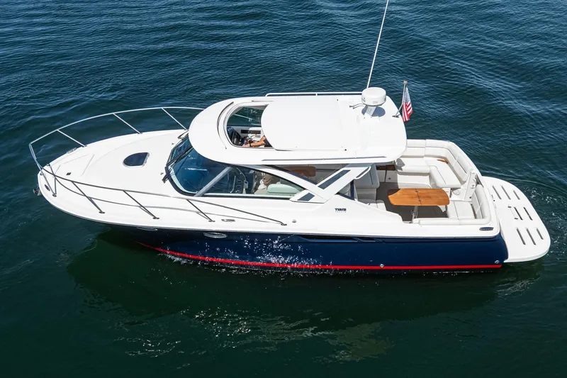 Slide: The Image of 2018 Tiara Yachts 3100 Coronet cruising on calm water, showcasing sleek design and spacious deck. - 11