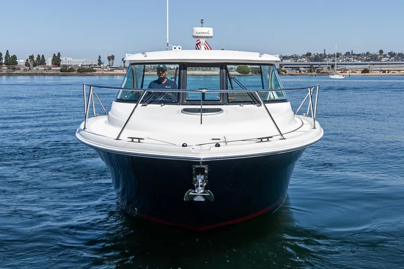 Slide: The Image of 2018 Tiara Yachts 3100 Coronet cruising on calm waters, front view. - 13