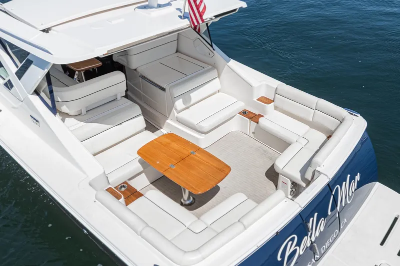 Slide: The Image of 2018 Tiara Yachts 3100 Coronet with spacious seating and wooden table on deck. - 17