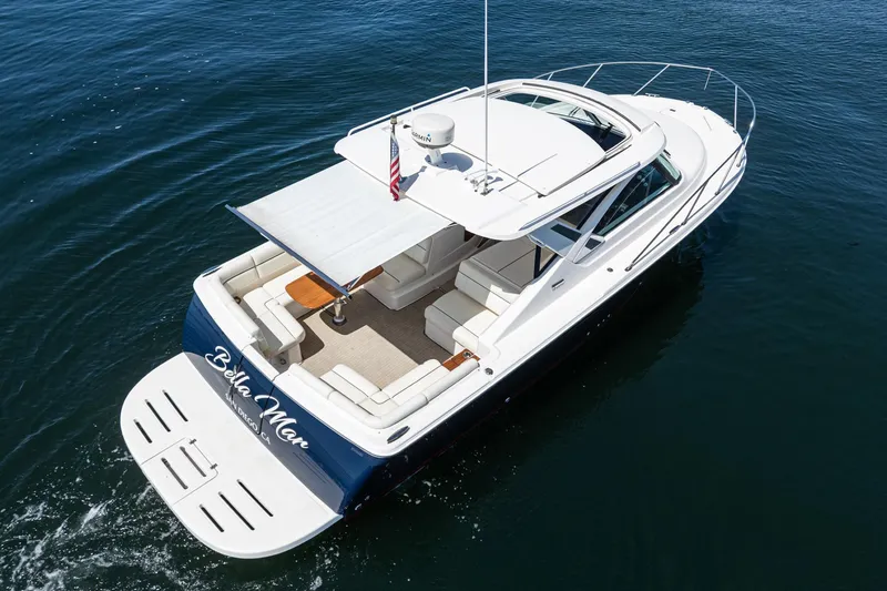 Slide: The Image of 2018 Tiara Yachts 3100 Coronet cruising on open water, featuring spacious deck and canopy. - 20