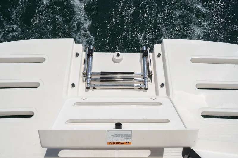 Slide: The Image of 2018 Tiara Yachts 3100 Coronet swim platform with ladder, on water. - 25