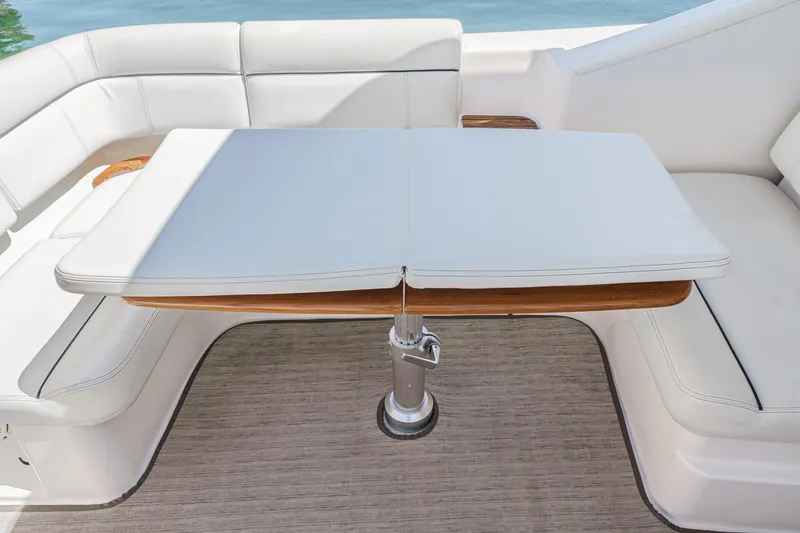 Slide: The Image of 2018 Tiara Yachts 3100 Coronet interior with white seating and adjustable table. - 28