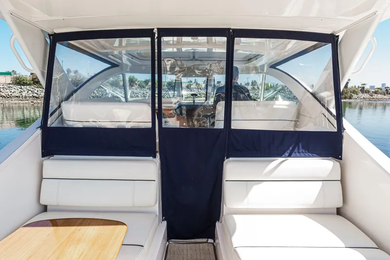 Slide: The Image of 2018 Tiara Yachts 3100 Coronet interior with seating and clear enclosure on a sunny day. - 29