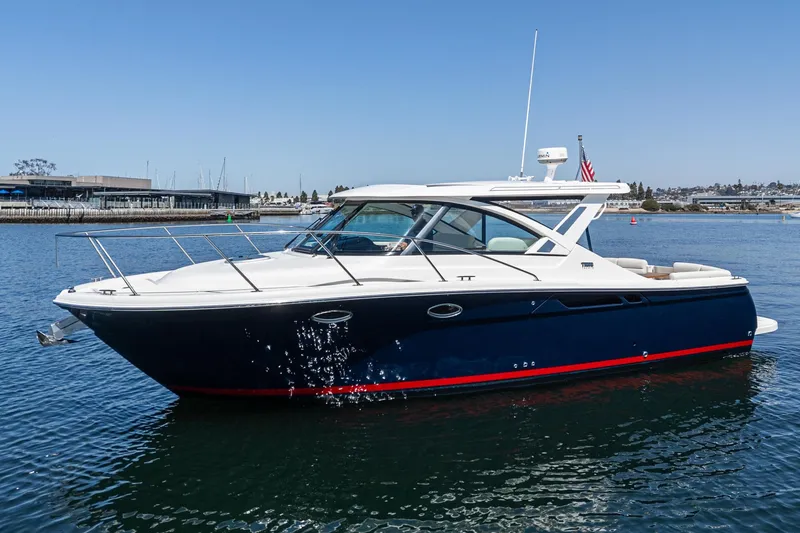 Slide: The Image of 2018 Tiara Yachts 3100 Coronet cruising on calm waters, showcasing sleek design and luxury. - 3