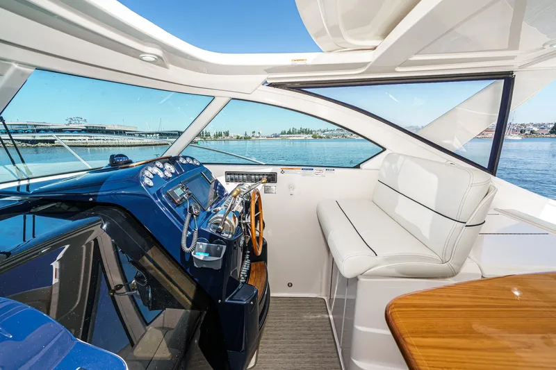 Slide: The Image of 2018 Tiara Yachts 3100 Coronet interior with helm, seating, and ocean view. - 38