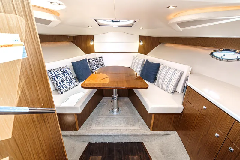 Slide: The Image of 2018 Tiara Yachts 3100 Coronet interior with elegant seating and wooden table. - 49