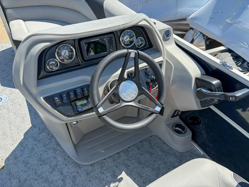Slide: The Image of Steering console of 2025 Trifecta 22 UL LE T 2.75 pontoon boat, featuring modern controls. - 13