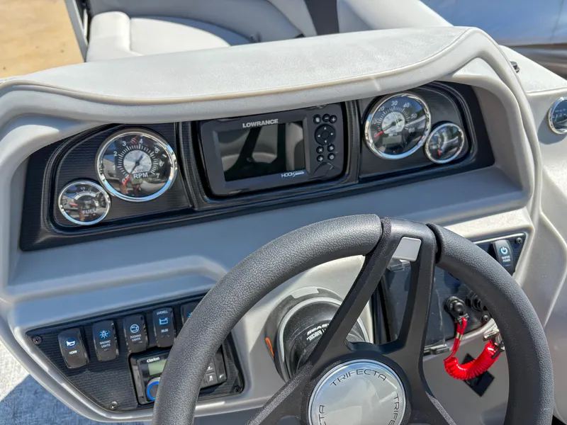 Slide: The Image of Steering console of 2025 Trifecta 22 UL LE T 2.75 boat with gauges and controls. - 14
