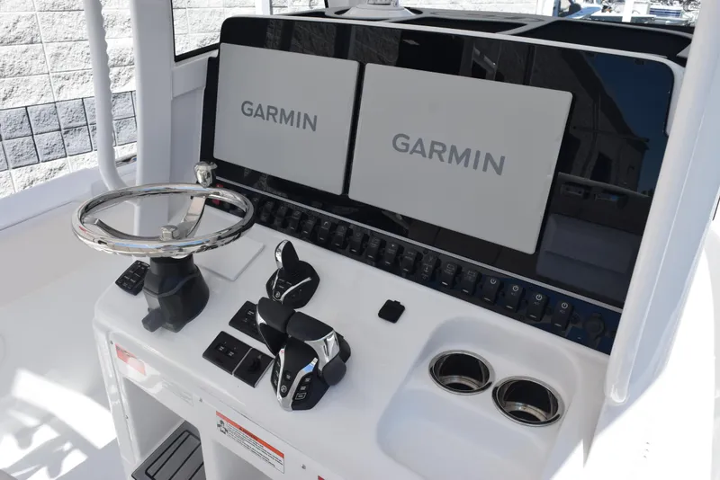 Slide: The Image of 2025 Sea Hunt Gamefish 28 helm with dual Garmin displays and modern controls. - 10