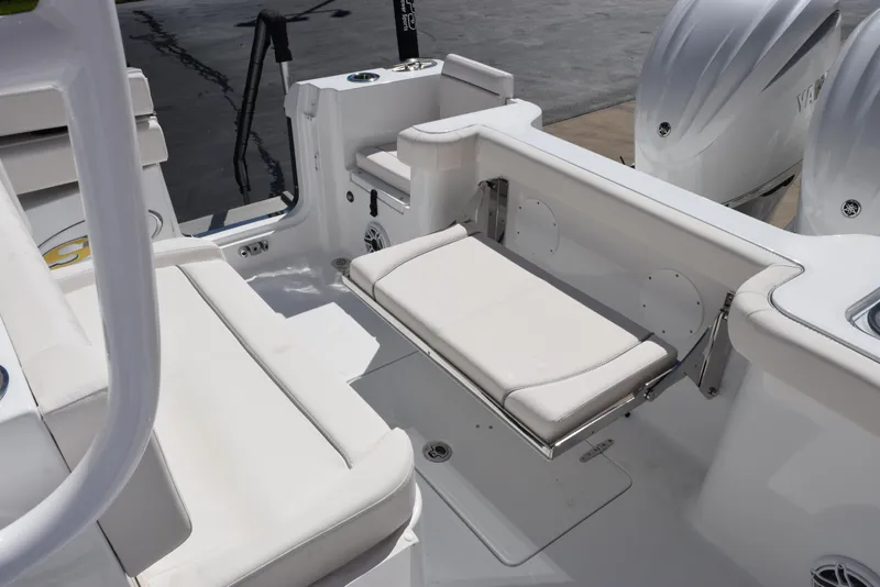 Slide: The Image of 2025 Sea Hunt Gamefish 28 boat interior with white seating and dual engines. - 17