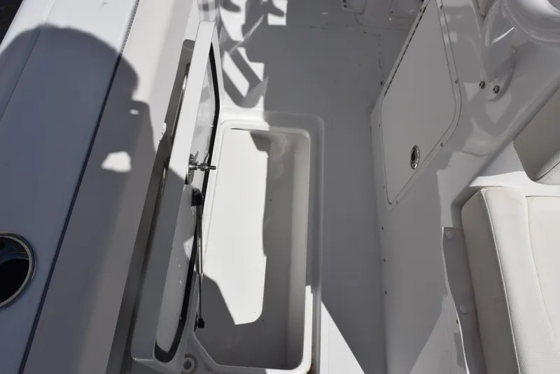 Slide: The Image of 2025 Sea Hunt Gamefish 28 interior showing storage compartment and seating area. - 19