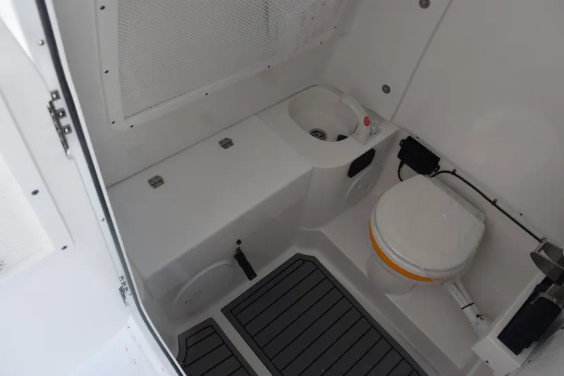 Slide: The Image of 2025 Sea Hunt Gamefish 28 boat interior with toilet and sink. - 23