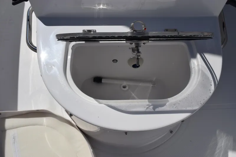 Slide: The Image of Livewell on 2025 Sea Hunt Gamefish 28 boat, open lid, white interior. - 26