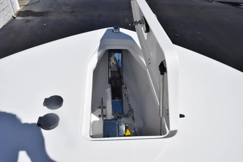 Slide: The Image of 2025 Sea Hunt Gamefish 28 anchor locker with open hatch, showcasing chain and anchor storage. - 27