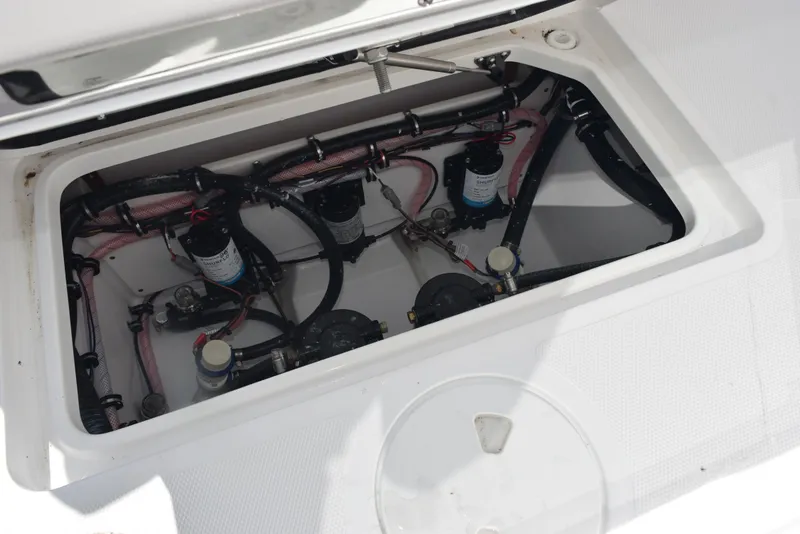 Slide: The Image of 2025 Sea Hunt Gamefish 28 boat compartment with visible wiring and components. - 28