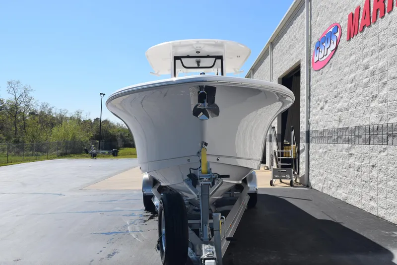Slide: The Image of 2025 Sea Hunt Gamefish 28 boat on trailer outside a marine dealership. - 3