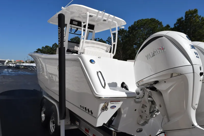 Slide: The Image of 2025 Sea Hunt Gamefish 28 boat with Yamaha outboard motor, parked on a trailer. - 6