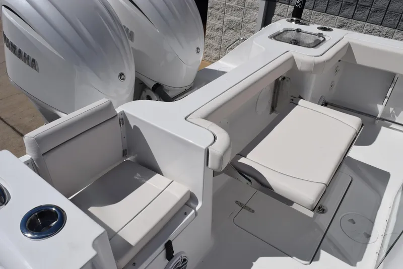 Slide: The Image of 2025 Sea Hunt Gamefish 28 boat interior with seating and dual engines. - 7