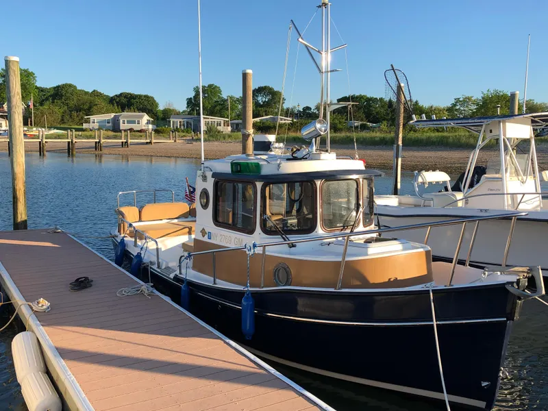 Slide: The Image of 2013 Ranger Tugs R-21 EC docked at a marina, sunny day, calm waters. - 5