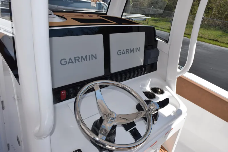 Slide: The Image of Steering console of 2025 Sea Hunt Ultra 265 SE with dual Garmin displays. - 11