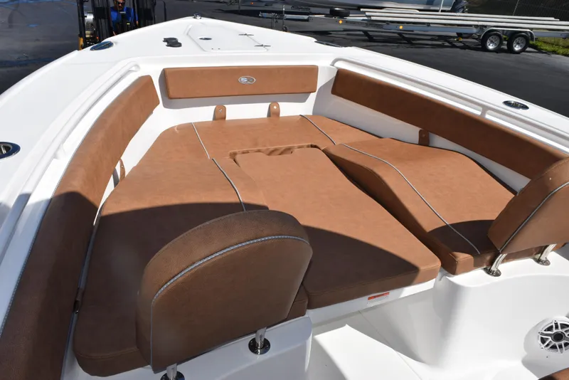 Slide: The Image of 2025 Sea Hunt Ultra 265 SE boat interior with brown cushioned seating. - 12