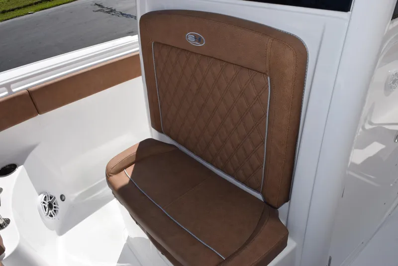 Slide: The Image of 2025 Sea Hunt Ultra 265 SE boat seat with brown upholstery and diamond stitching. - 13