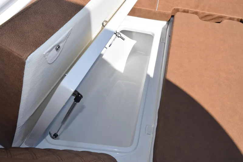 Slide: The Image of Storage compartment on 2025 Sea Hunt Ultra 265 SE boat with brown cushioned seating. - 17