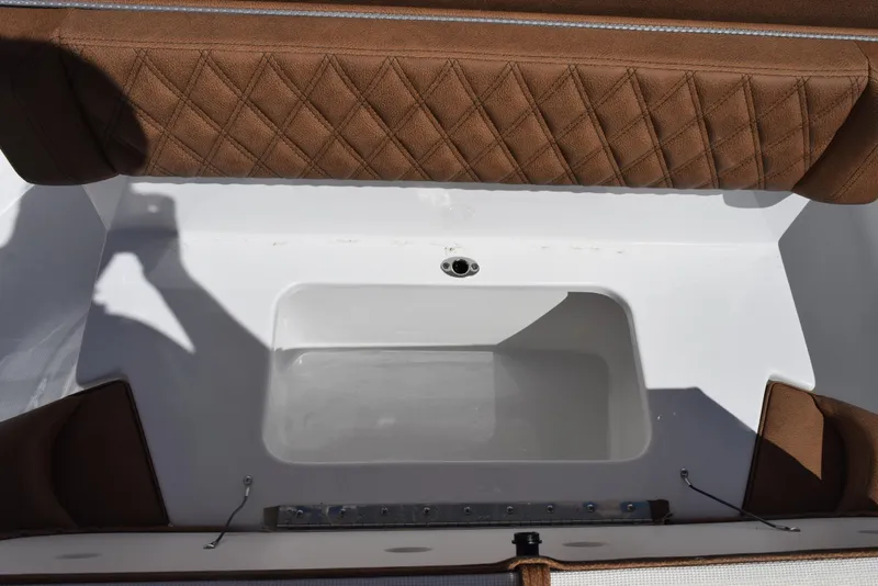 Slide: The Image of 2025 Sea Hunt Ultra 265 SE boat interior with cushioned seating and storage compartment. - 19