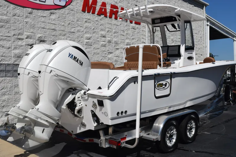 Slide: The Image of 2025 Sea Hunt Ultra 265 SE boat with dual Yamaha engines on a trailer. - 3