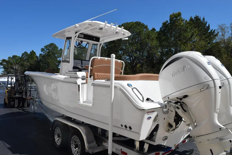 Slide: The Image of 2025 Sea Hunt Ultra 265 SE boat on trailer, featuring dual engines and sleek design. - 5