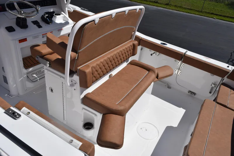 Slide: The Image of 2025 Sea Hunt Ultra 265 SE boat interior with brown cushioned seating and white deck. - 6