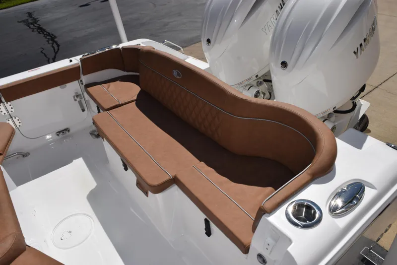Slide: The Image of 2025 Sea Hunt Ultra 265 SE boat with brown seating and dual outboard engines. - 7