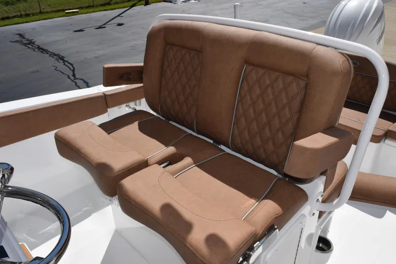 Slide: The Image of 2025 Sea Hunt Ultra 265 SE boat with tan cushioned seating and steering wheel. - 9