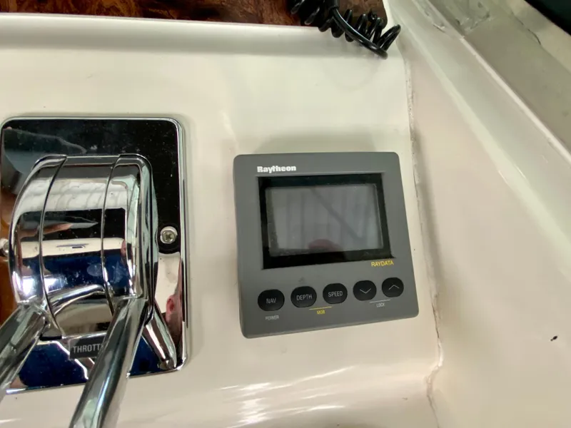 Slide: The Image of Raytheon marine display and throttle controls on 1997 Sea Ray 400 Sundancer yacht. - 17