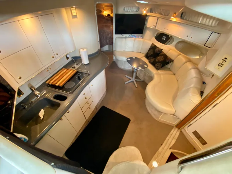 Slide: The Image of Luxurious interior of 1997 Sea Ray 400 Sundancer yacht with kitchen and seating area. - 18