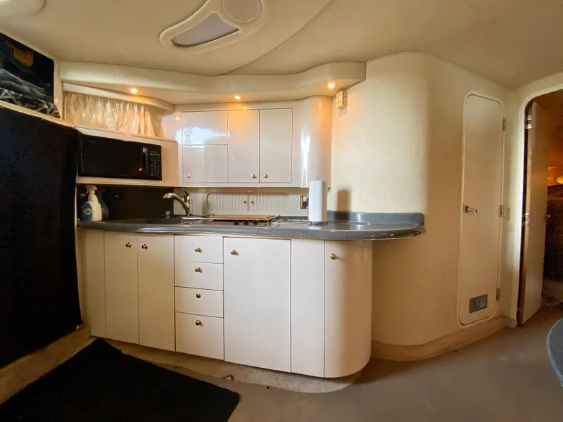 Slide: The Image of 1997 Sea Ray 400 Sundancer yacht kitchen with modern cabinetry and appliances. - 22