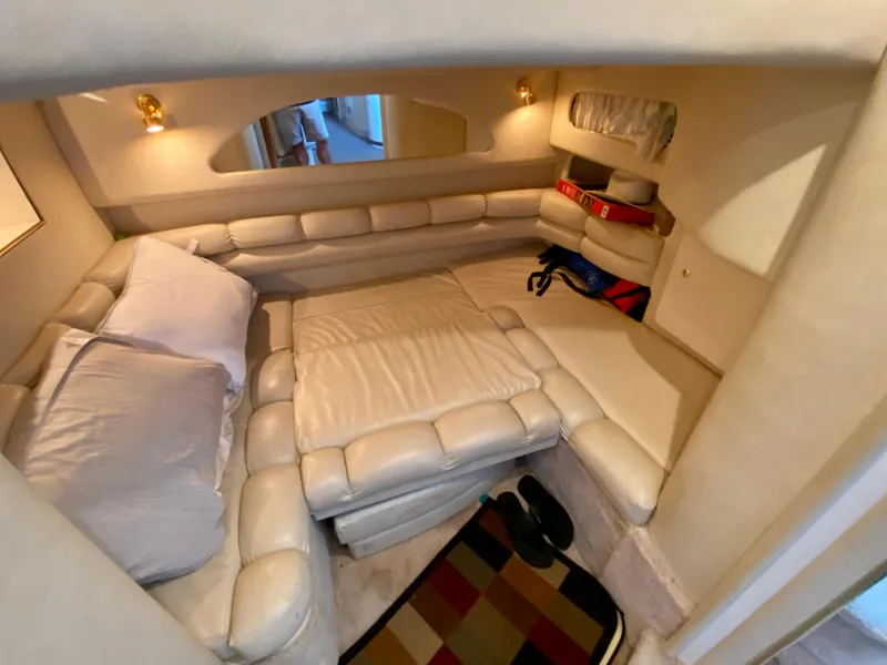 Slide: The Image of 1997 Sea Ray 400 Sundancer cabin with plush seating and cozy interior design. - 24