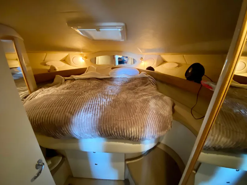 Slide: The Image of Cozy bedroom interior of 1997 Sea Ray 400 Sundancer yacht with plush bedding. - 26